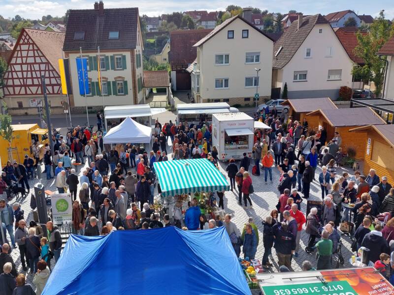 Viele Besucher auf dem Rathausplatz in Wössingen. Es sind verschiedene Stände zu sehen und Pavillions.